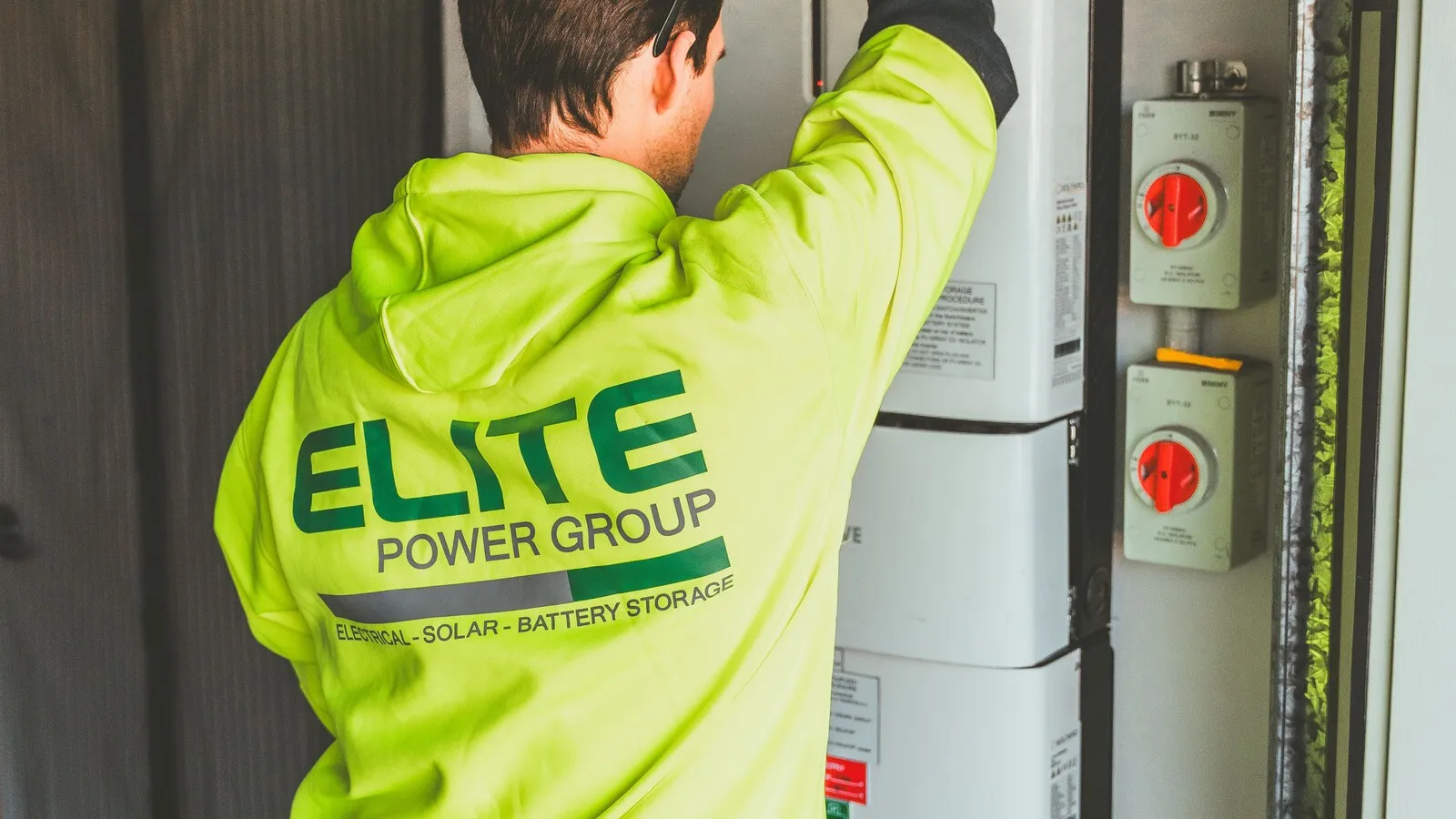 An installer inspecting a home battery storage unit
