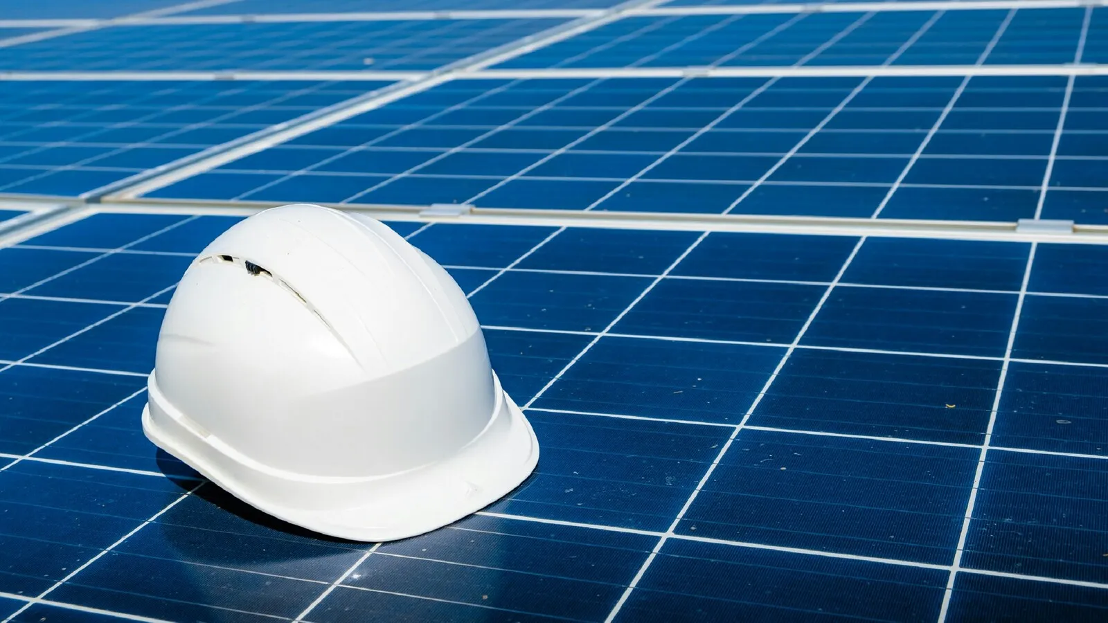 A safety helmet resting on an array of solar panels